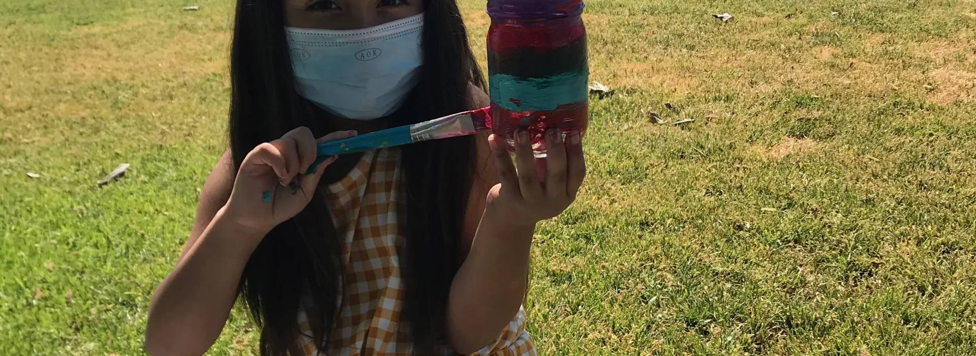 juarez student painting her project outdoors