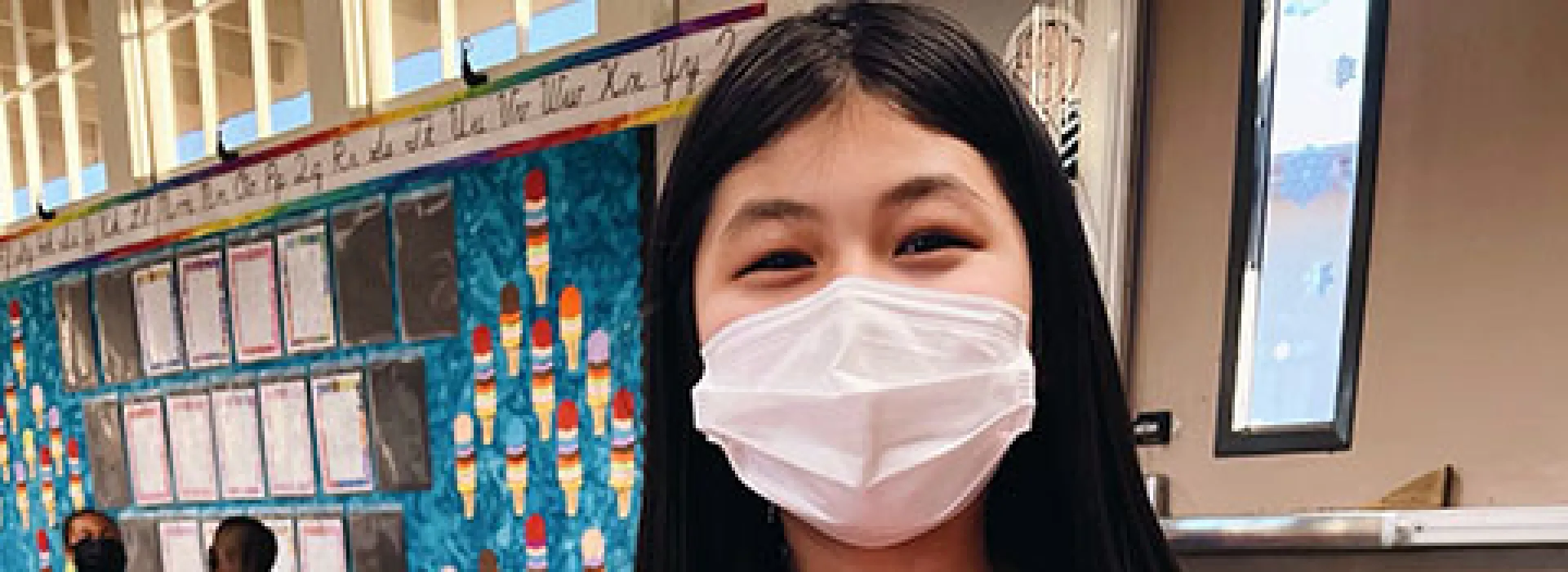 Burbank student creating a heart shaped craft